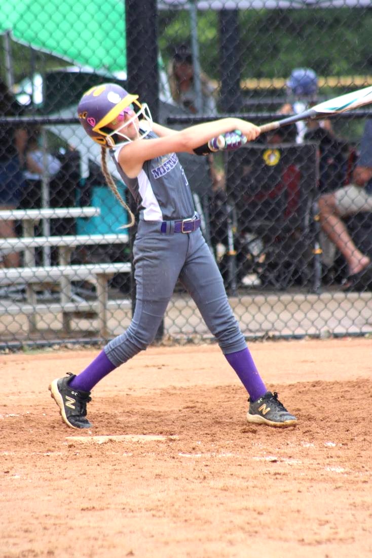 Mustangs player swinging the bat